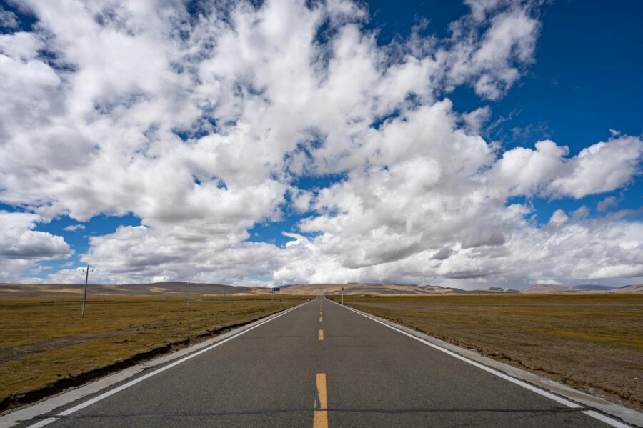 open road under a vast blue sky